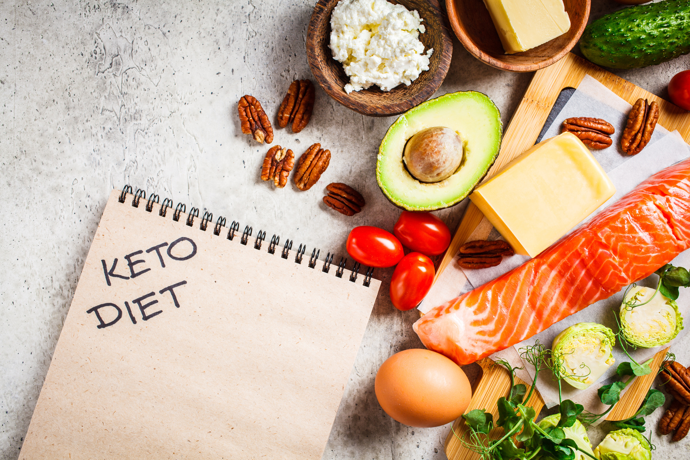 Keto diet food concept. Fish, eggs, cheese, nuts, butter and vegetables - ingredients keto diet.